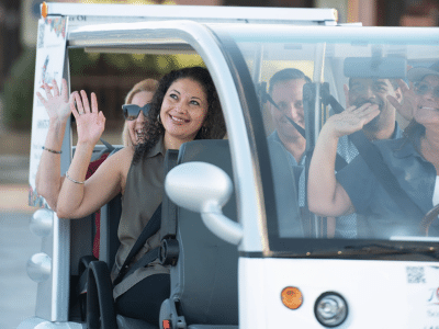 waving from golf cart